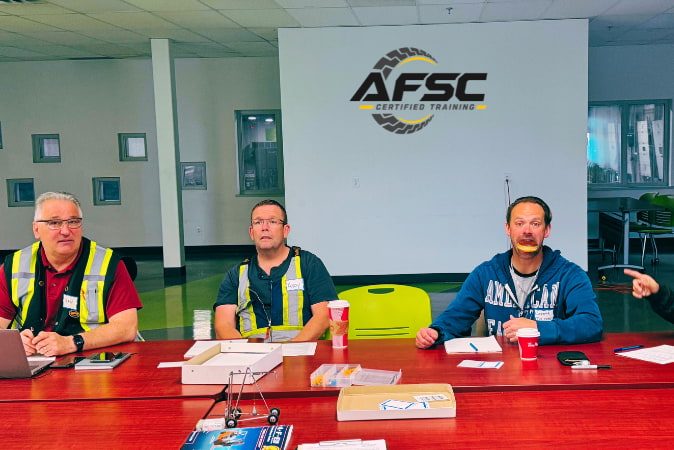Trainer reviewing operator certification documentation